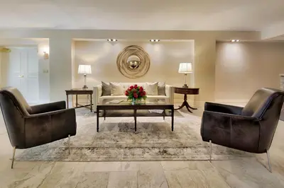 a living room with a couch and two chairs at Inn On The Twenty in Jordan