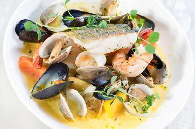 a white plate of food with shrimp and mussels at Inn On The Twenty in Jordan