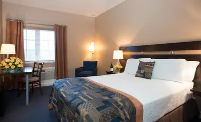a hotel room with a large bed and a desk at Jordan House Hotel in Jordan