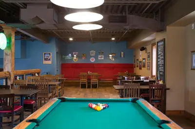 a pool table in a restaurant with tables and chairs at Jordan House Hotel in Jordan