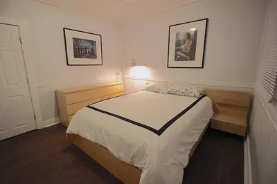 a bedroom with a bed and a lamp in it at Maison Doucet in Niagara Falls