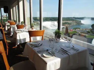 a restaurant with tables with wine glasses and a view at Maison Doucet in Niagara Falls
