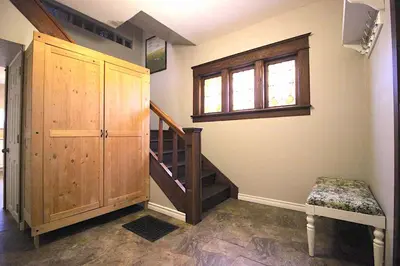 a room with a wooden cabinet and a staircase at Maison Doucet in Niagara Falls