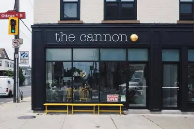 a store front with a yellow bench in front of it at Doucet Guesthouse in Hamilton