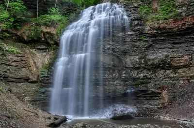a waterfall on the side of a rocky cliff at Doucet Guesthouse in Hamilton