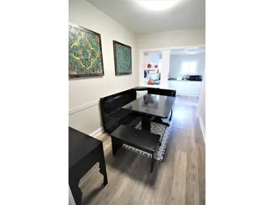 a living room with a black table and chairs at Doucet Guesthouse in Hamilton