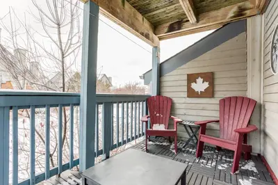 two red chairs sitting on a porch with a table at Blue Mountain (1 bedroom) Escape at North Creek Resort in Blue Mountains