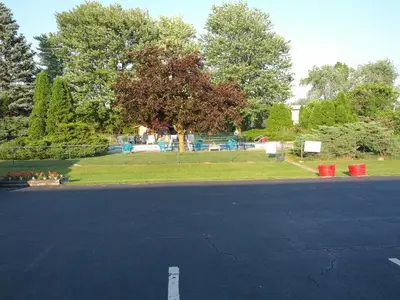 a parking lot with a park in the background at Majers Motel in Stratford