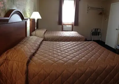 a hotel room with two beds and a window at Majers Motel in Stratford