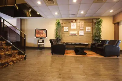 a waiting room with chairs and a tv in it at Quality Inn in Bracebridge