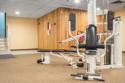 a gym with exercise equipment in a building at Quality Inn in Bracebridge