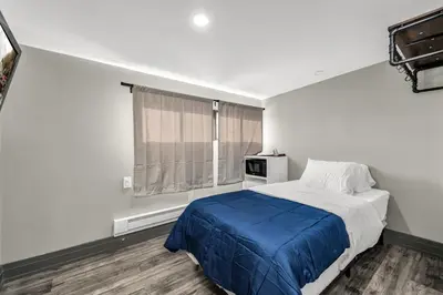 a bedroom with a bed and a window at Park Motel in Toronto