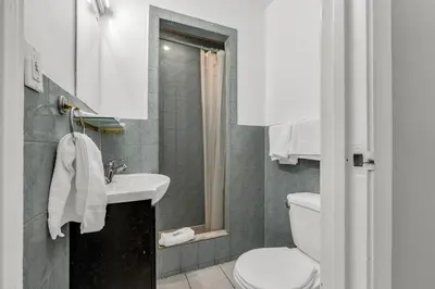 a bathroom with a sink and a toilet at Park Motel in Toronto