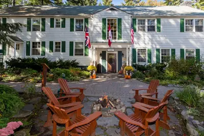 a group of chairs around a fire pit in front of a house at Sherwood Inn in Port Carling