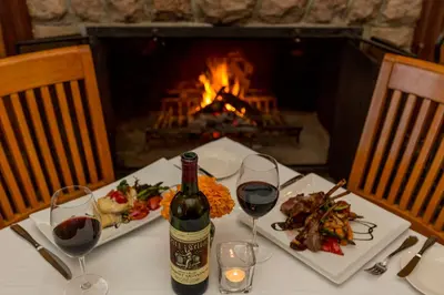 a table with a bottle of wine and two glasses at Sherwood Inn in Port Carling