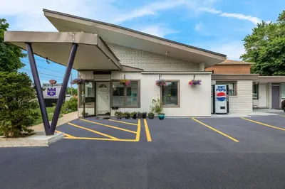 a gas station with a pump in a parking lot at Knights Inn Burlington in Burlington