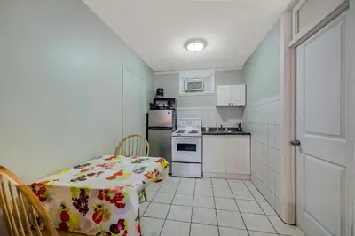 a small kitchen with a table and a stove at Knights Inn Burlington in Burlington