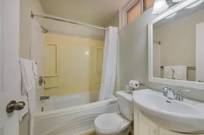 a bathroom with a sink and a toilet and a tub at Knights Inn Burlington in Burlington