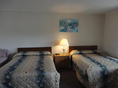 a hotel room with two beds and a lamp at Hipwell's Motel in Fonthill