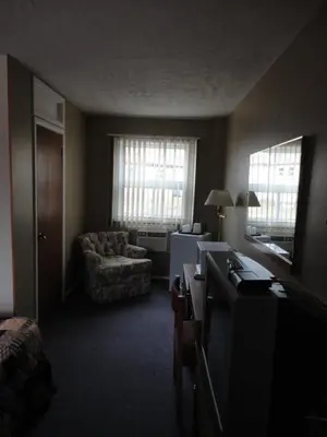 a living room with a couch and a chair at Hipwell's Motel in Fonthill