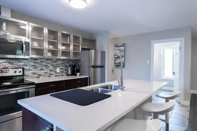 a kitchen with a sink and a counter top at ENTIRE 2 BEDROOM APARTMENT UPTOWN WATERLOO - e3 in Waterloo