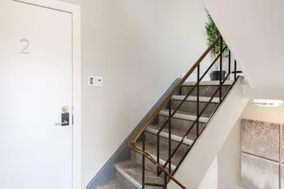 a staircase in a house with a plant at ENTIRE 2 BEDROOM APARTMENT UPTOWN WATERLOO - e2 in Waterloo
