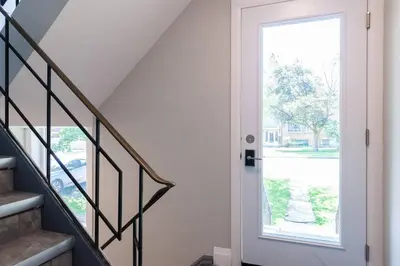 a staircase with a door and a window at ENTIRE 2 BEDROOM APARTMENT UPTOWN WATERLOO - e2 in Waterloo