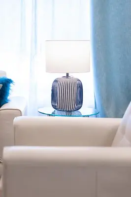 a table with a lamp on top of a white couch at ENTIRE 2 BEDROOM APARTMENT UPTOWN WATERLOO - e2 in Waterloo