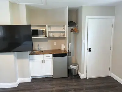 a kitchen with white cabinets and a white door at ENTIRE BACHELOR UNIT EN-SUITE UPTOWN WATERLOO - e5 in Waterloo