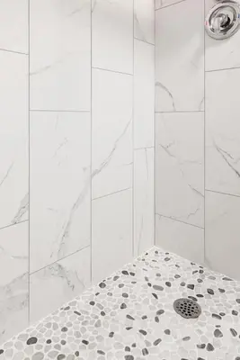 a bathroom with a shower with a drain at ENTIRE BACHELOR UNIT EN-SUITE UPTOWN WATERLOO - e5 in Waterloo