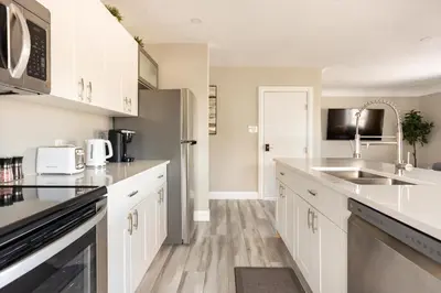 a kitchen with white cabinets and a sink at ENTIRE 2 BEDROOM APARTMENT DOWNTOWN - u3 in Waterloo