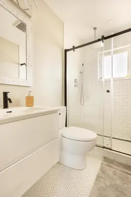 a white bathroom with a toilet and a shower at ENTIRE 2 BEDROOM APARTMENT DOWNTOWN - u3 in Waterloo