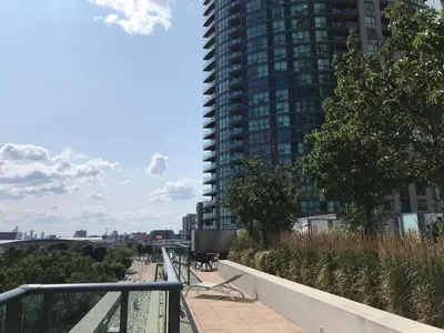 a balcony with benches and a tall building at Executive 1 Bedroom Condo sleeps 2 in Toronto
