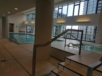 a large building with a swimming pool and a staircase at Executive 1 Bedroom Condo sleeps 2 in Toronto