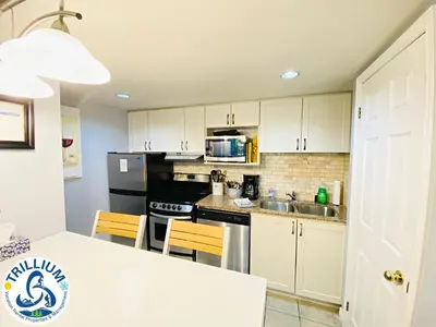 a kitchen with white cabinets and a white counter top at Slopeside Blue Mountain Condo - Wifi, Linens/Towels, Ski In/Out in Blue Mountains