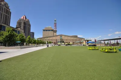 a large field of grass in a city with buildings at Royal Stays Furnished Apartments - Square One in Mississauga