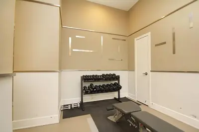 a room with a gym with a bench in it at Royal Stays Furnished Apartments - Square One in Mississauga