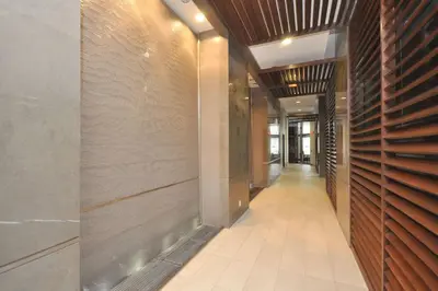 a hallway of a building with wooden walls and a hallwayngth at Royal Stays Furnished Apartments - Square One in Mississauga