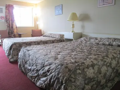 a hotel room with two beds and a window at Newburg Inn Motel in New Hamburg
