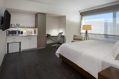 a hotel room with a bed and a desk and a kitchen at Element Vaughan Southwest in Vaughan