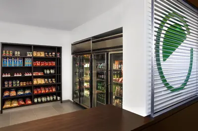 a grocery store with a refrigerator and shelves of food at Element Vaughan Southwest in Vaughan