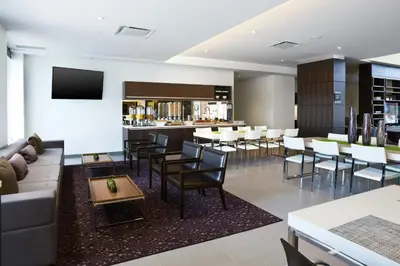 a restaurant with a couch and chairs and a bar at Element Vaughan Southwest in Vaughan