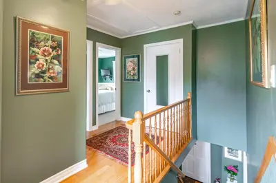 a staircase in a home with green walls at Abacot Hall Bed & Breakfast in Niagara on the Lake