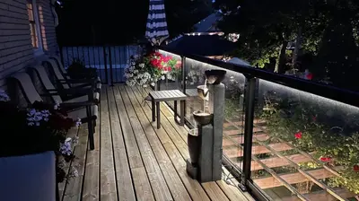 a wooden deck with a bench and a bird feeder at Abacot Hall Bed & Breakfast in Niagara on the Lake