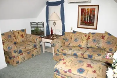 a living room with a couch and a chair at Burley's Executive Garden Suite in Peterborough