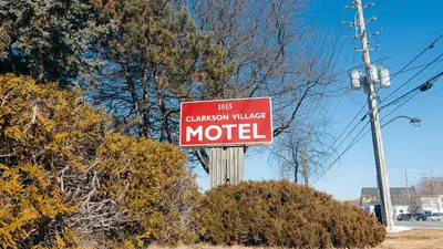 a red sign that reads las canyon village motel at Clarkson Village Motel, 1815 Lakeshore Rd West Mississauga in Mississauga