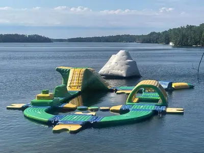 a water slide in the middle of a lake at Rocky Crest Golf Resort in MacTier