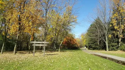 a sign in the middle of a field with trees at Comfort Stays near Toronto Airport in Mississauga