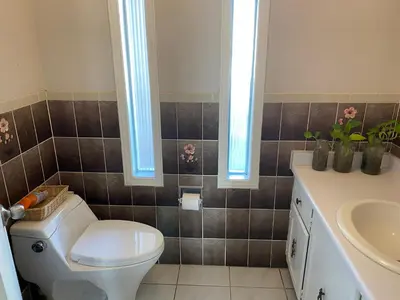 a bathroom with a toilet and a sink at Comfort Rooms Near Toronto Airport in Mississauga