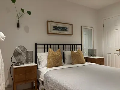 a bedroom with a bed with pillows and a fan at Clearbrooke Gem- Bright Private Bedroom close to YYZ in Toronto
